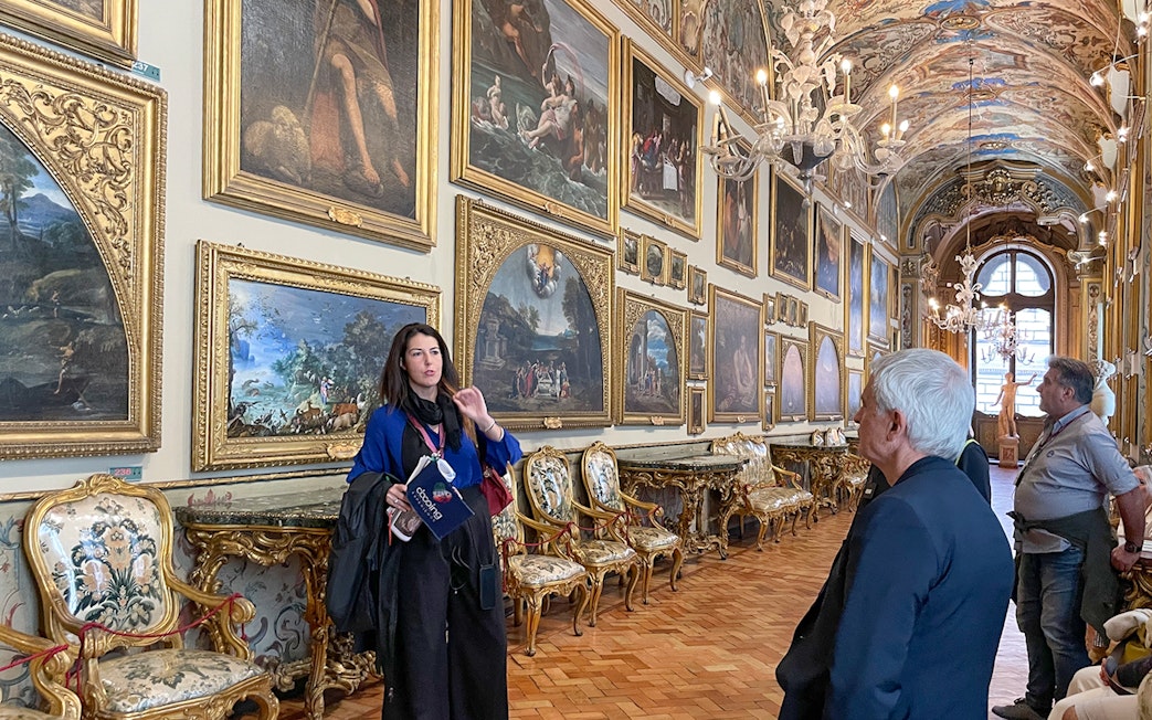 Guide explaining artwork in Doria Pamphilj Gallery, Rome tour.