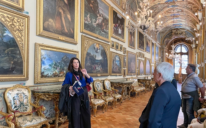 Guide explaining artwork in Doria Pamphilj Gallery, Rome tour.