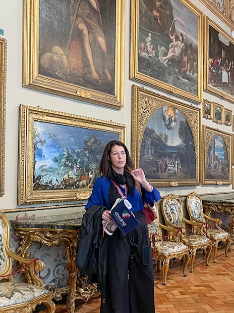 Guide explaining artwork in Doria Pamphilj Gallery, Rome tour.