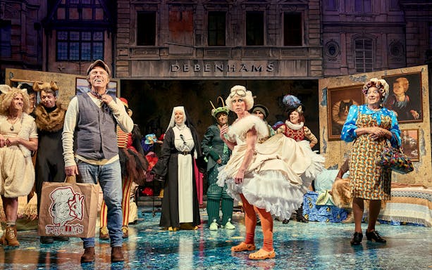 Theater cast in colorful costumes performing "Mother Goose" on stage.