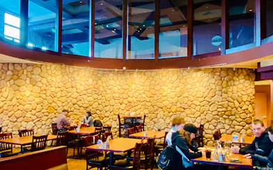 Fairbanks brewery interior with patrons seated at tables, part of the Arctic Ale Trail tour.