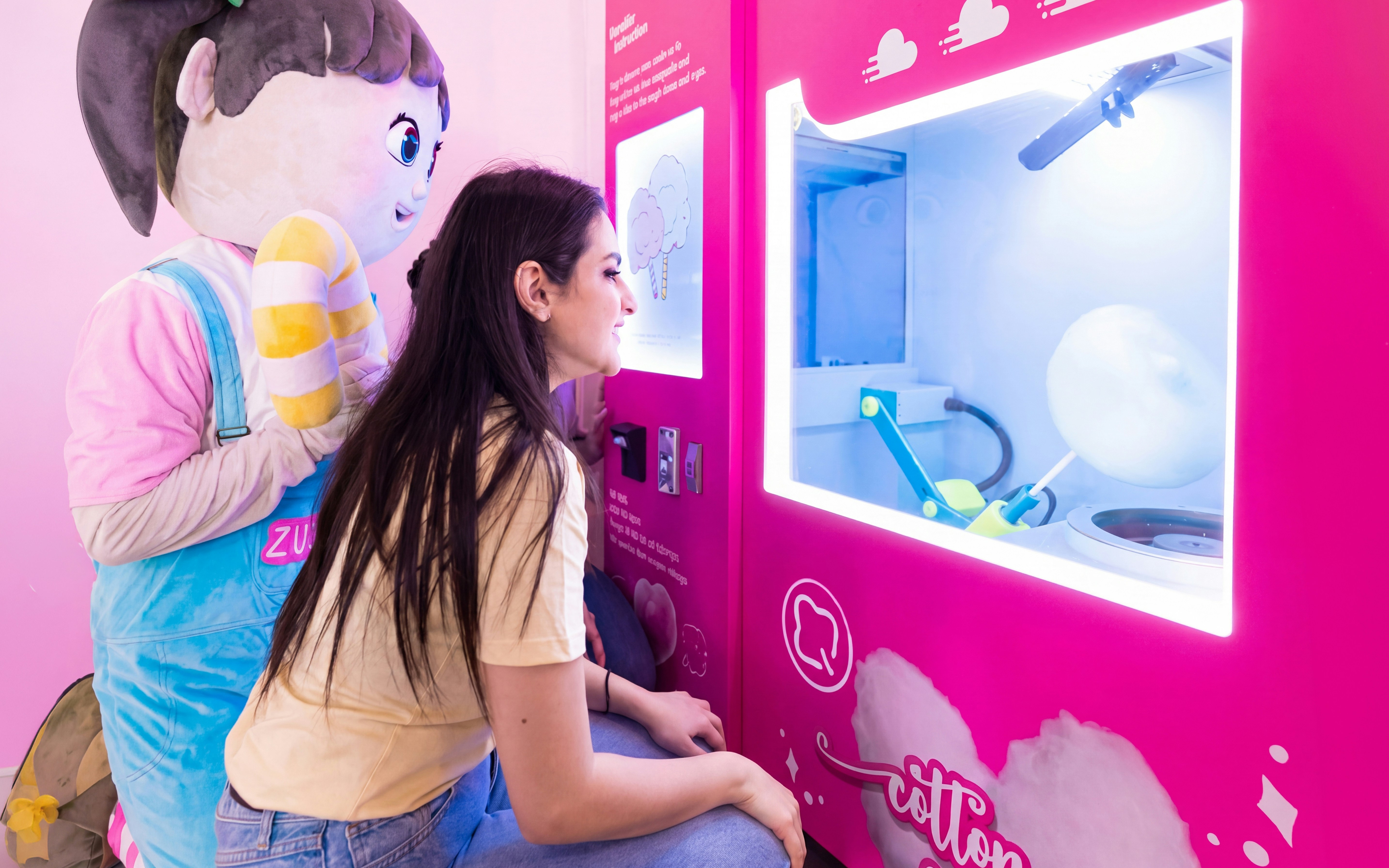 Visitor interacting with cotton candy machine at Museum of Candy, Dubai.