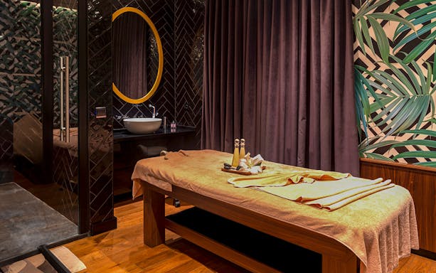 Massage table in a private Turkish bath in Istanbul with towels and spa items.