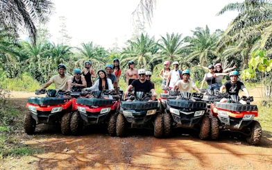 Group on ATVs in tropical Krabi forest during ATV Adventure & BB Gun Shooting Experience.