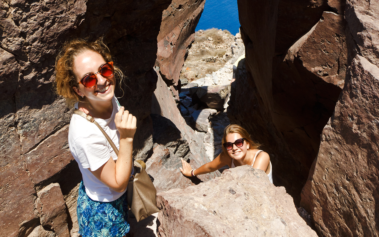 Guests hiking through rocky terrain on Santorini Volcanic cruise tour.