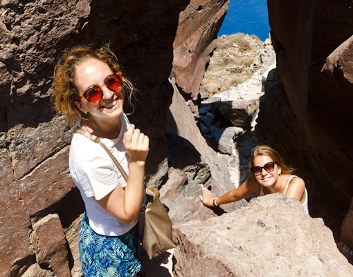 Guests hiking through rocky terrain on Santorini Volcanic cruise tour.