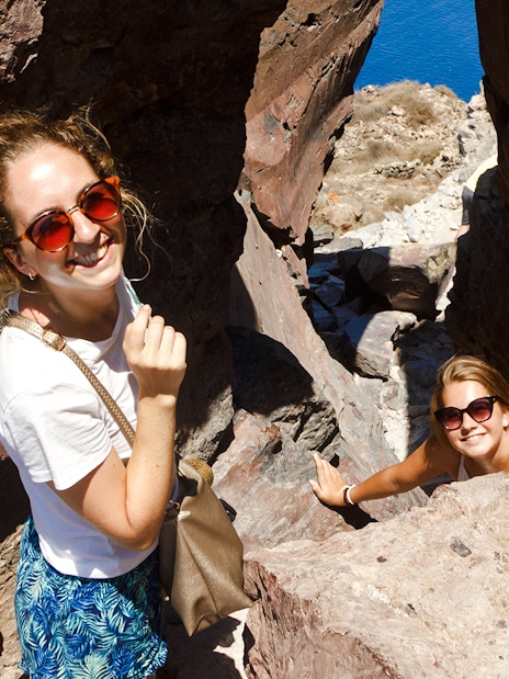 Guests hiking through rocky terrain on Santorini Volcanic cruise tour.