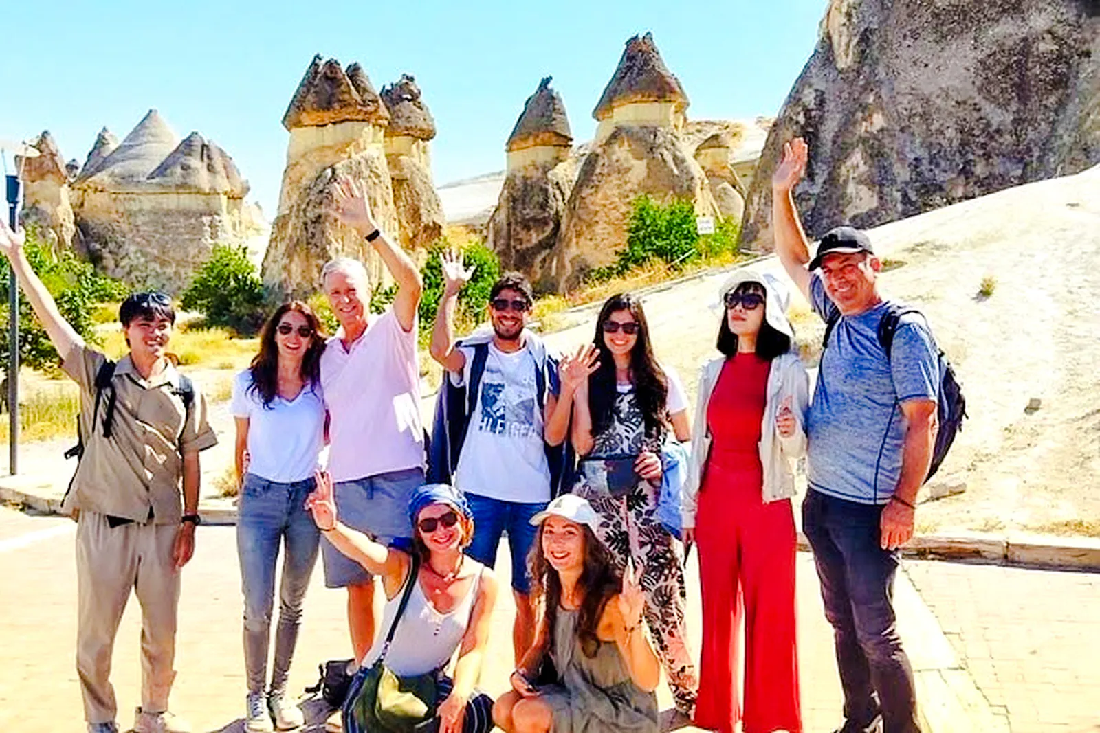 Group of tourists at Cappadocia's fairy chimneys during Red Tour, Turkey.