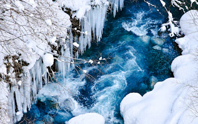Frozen river with icicles and snow in Hokkaido, part of Sapporo: Asahiyama Zoo, Blue Pond & Ningle Terrace Tour.