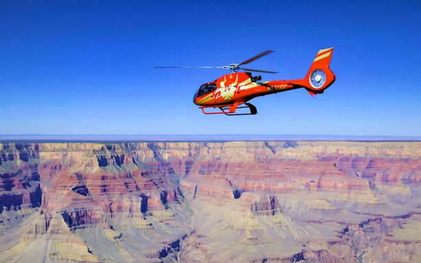 Helicopter flying over the Grand Canyon during Grand Kingdom Hummer Tour.