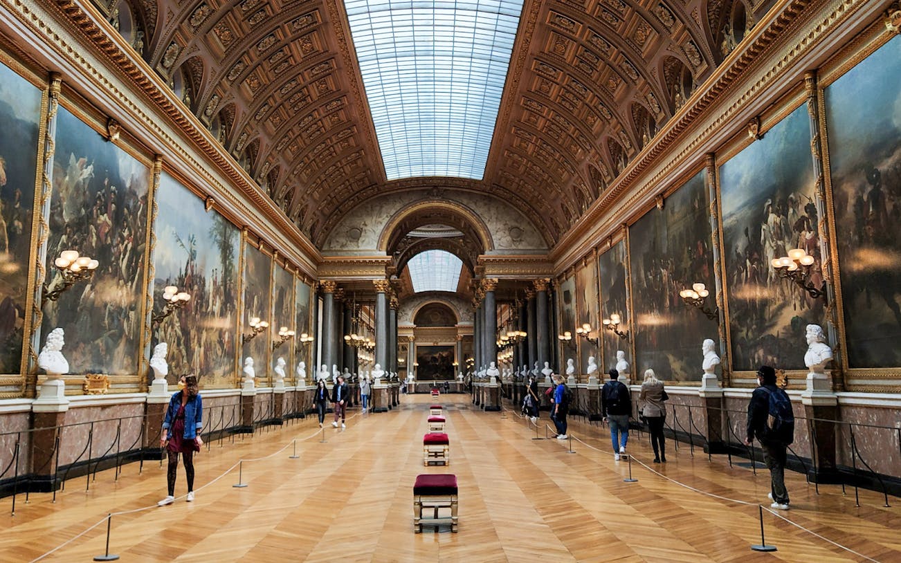VIP tour group in the Hall of Battles, Palace of Versailles, Paris.