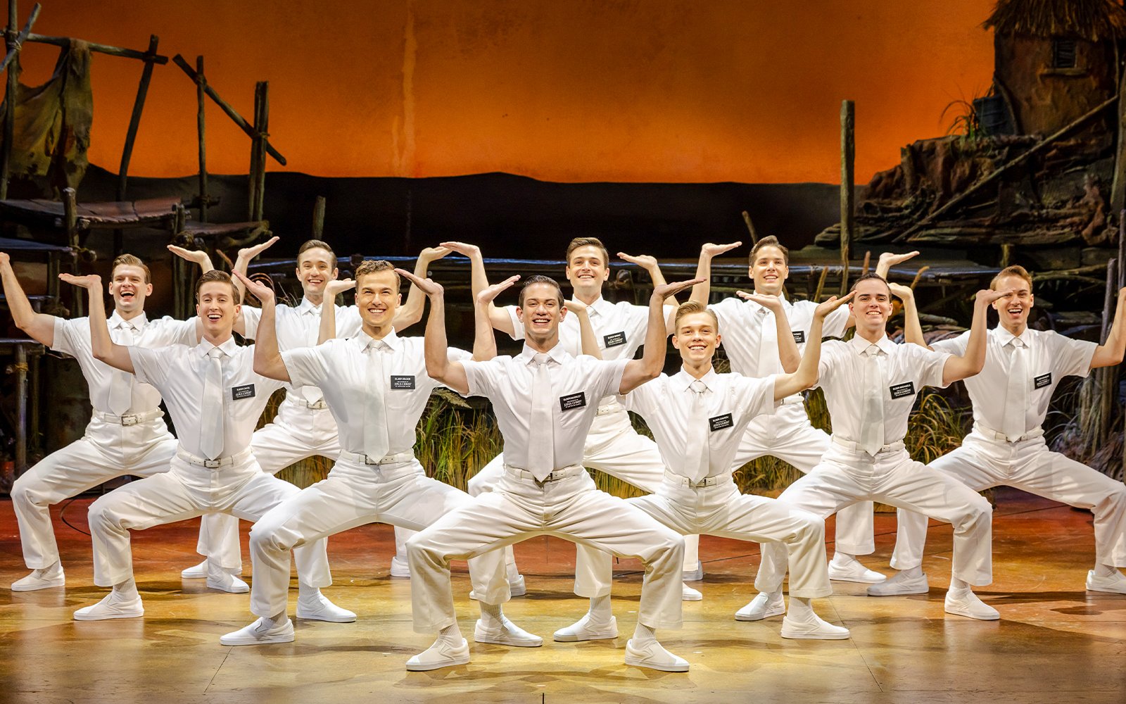 Cast performing The Book of Mormon on stage in Brisbane.