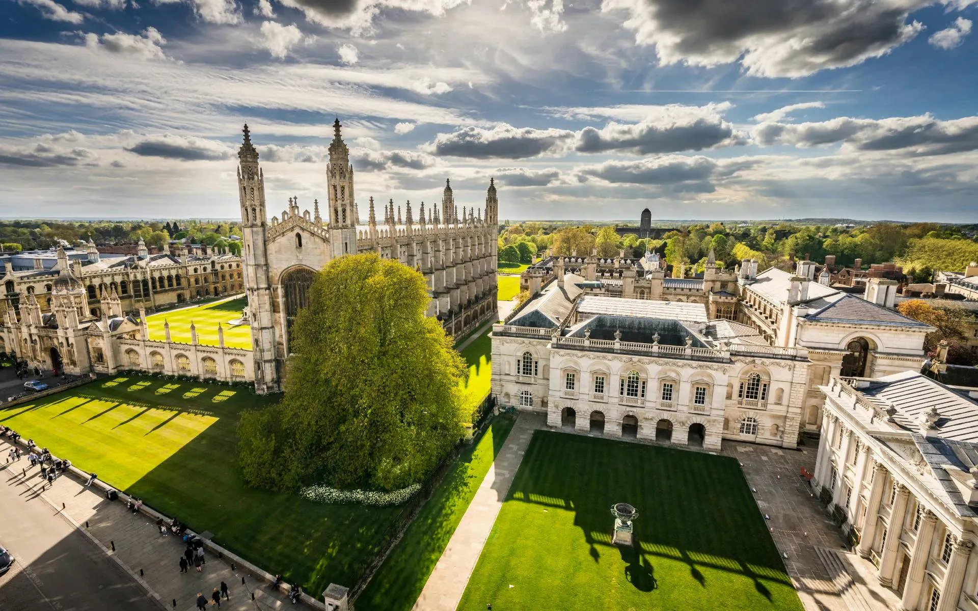 King's College Chapel and Senate House at University of Cambridge, view of historic architecture and green lawns.