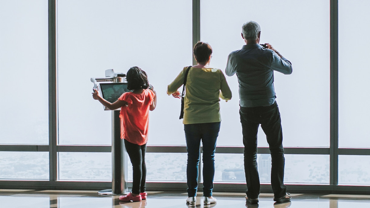 Family at The Shard, London, with a girl using a digital telescope.