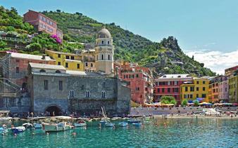 Colorful buildings and boats along the waterfront in Vernazza, Cinque Terre, Italy.