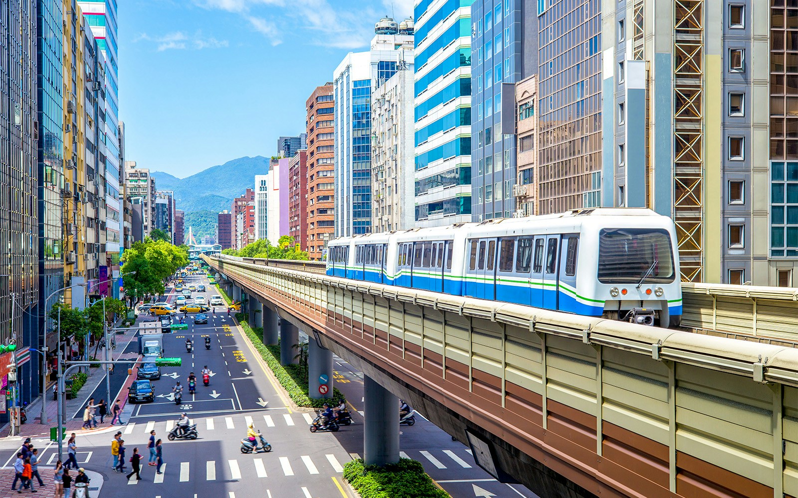 MRT train traveling through cityscape towards Floral Fantasy.