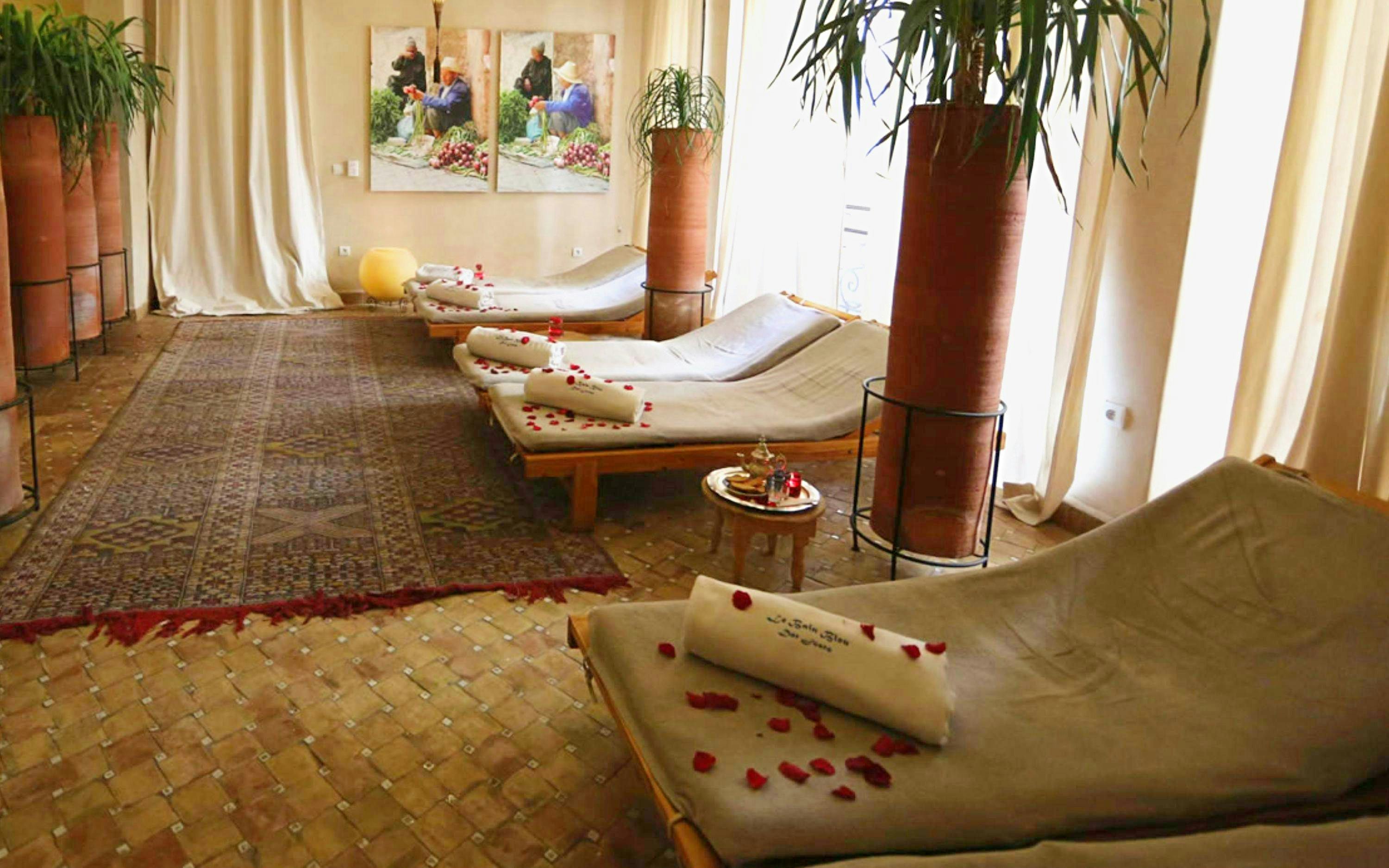 Loungers with rose petals at Le Bain Bleu Hammam & Spa, Marrakesh.