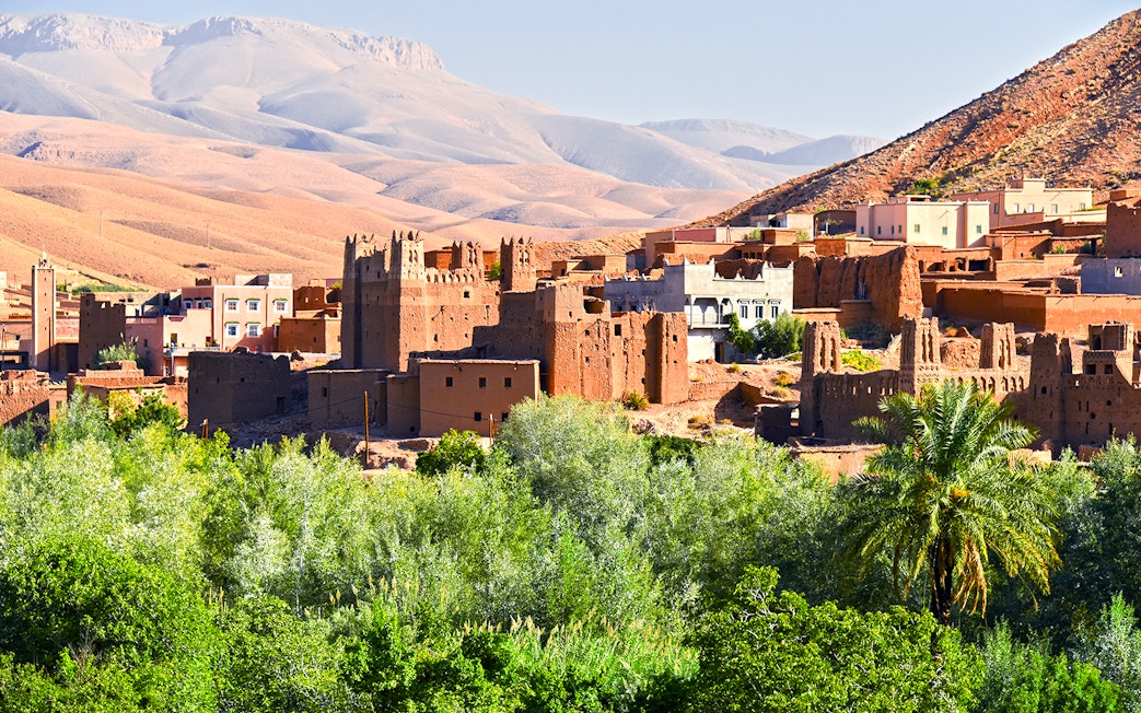 Old Berber architecture with palm trees near Tamellalt, Morocco.