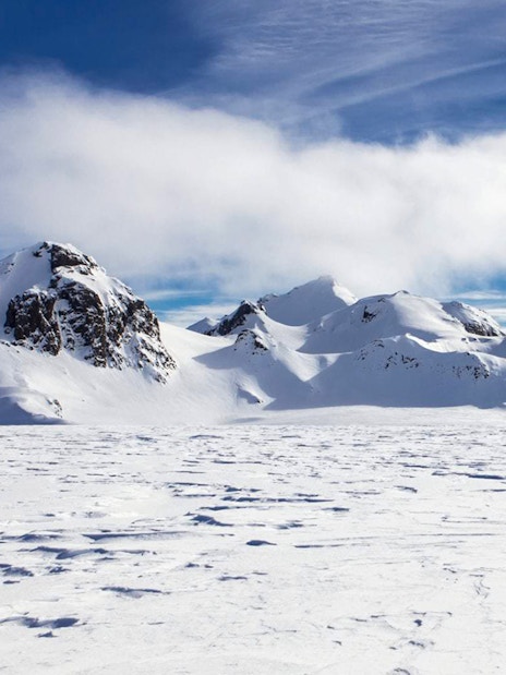 Langjökull Glacier's snowy peaks under a clear blue sky in Iceland.
