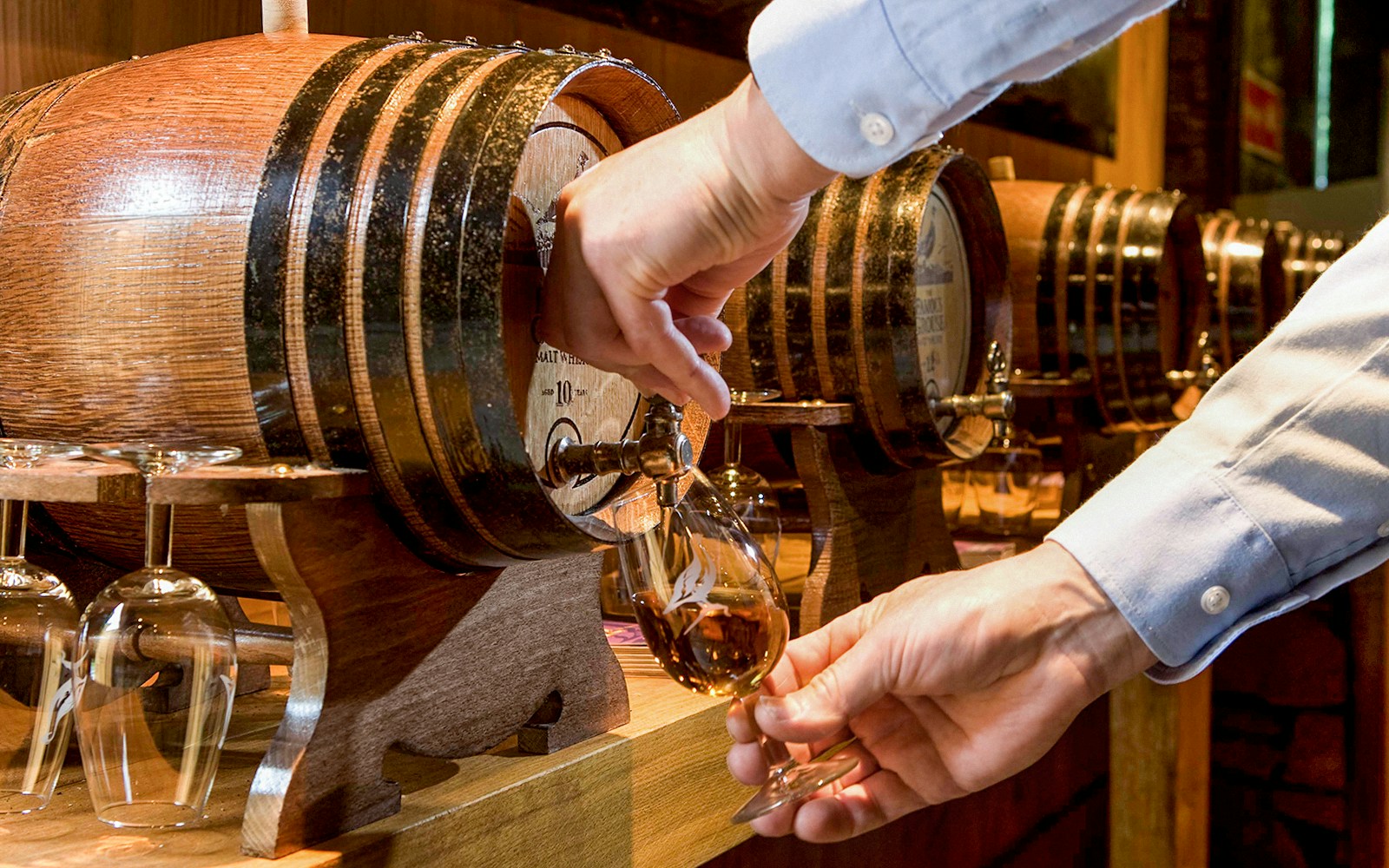 Pouring whisky from a barrel during The Ultimate Whisky Experience in Edinburgh.
