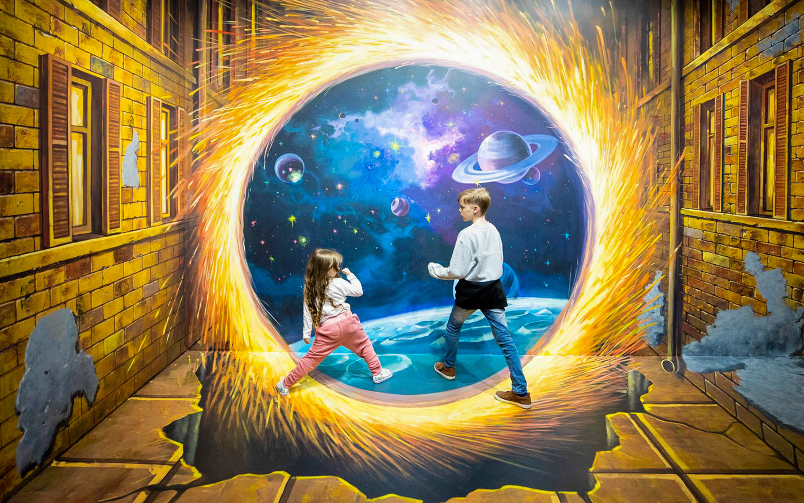 Children interacting with space-themed illusion at ArtVo Illusions Gold Coast.