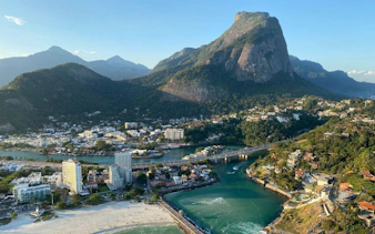 Praia da Joatinga coastline and Pedra da Gávea mountain during Rio de Janeiro helicopter tour.