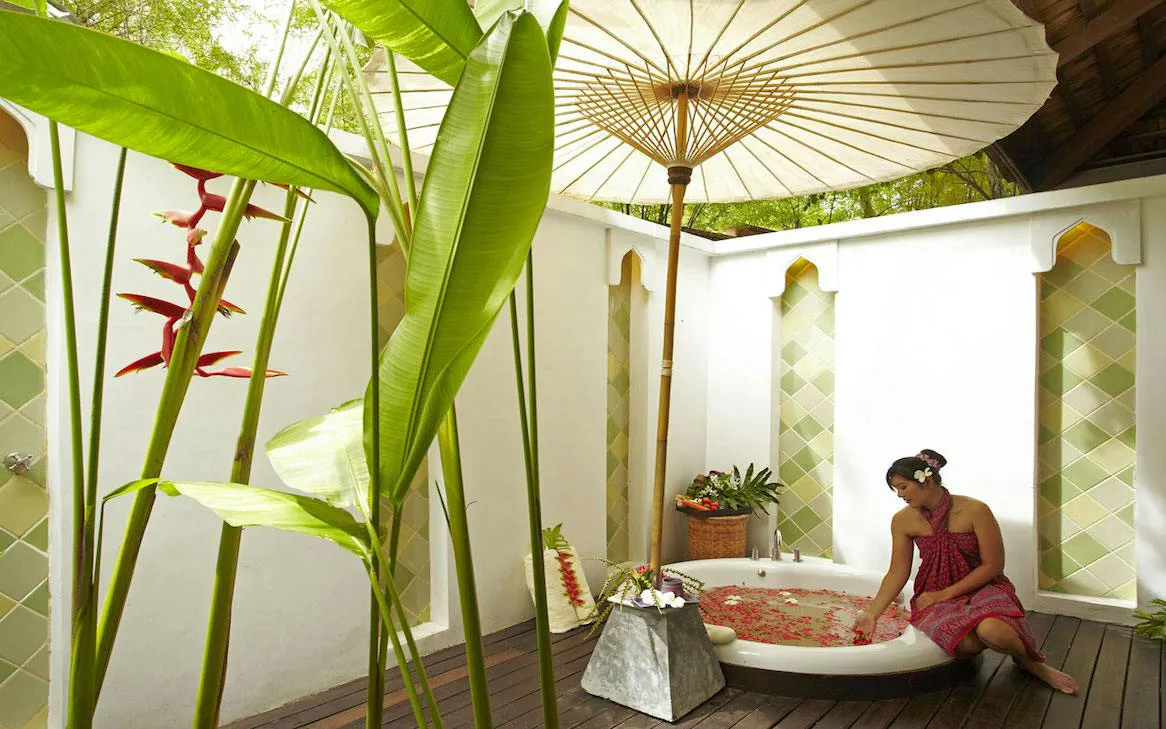 Woman enjoying a flower bath at Melati Beach Resort & Spa, Ko Samui.