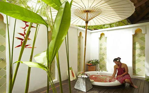 Woman enjoying a flower bath at Melati Beach Resort & Spa, Ko Samui.