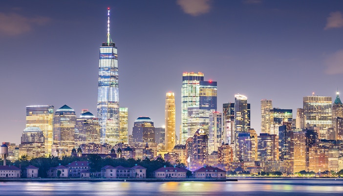 New York, New York, USA skyline from the harbor with Ellis Island