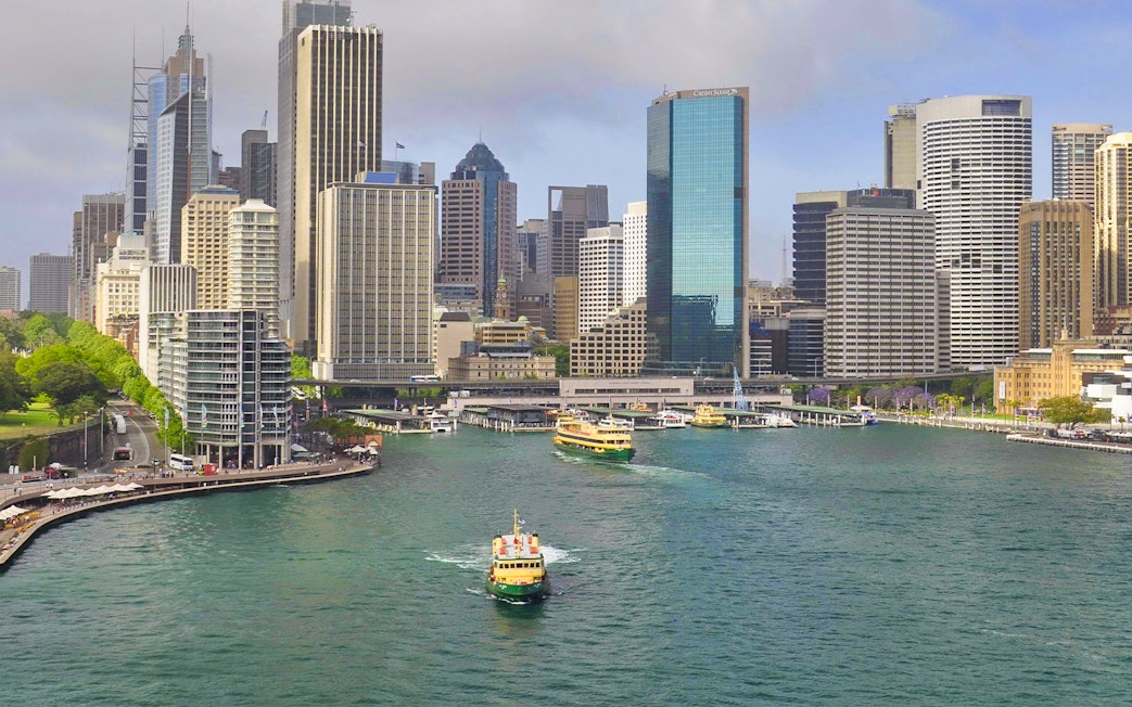 Ferry cruising through Sydney Harbour with city skyline in the background.