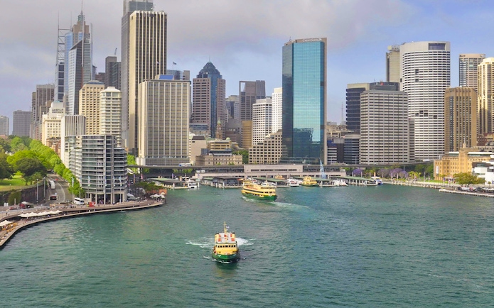 Ferry cruising through Sydney Harbour with city skyline in the background.