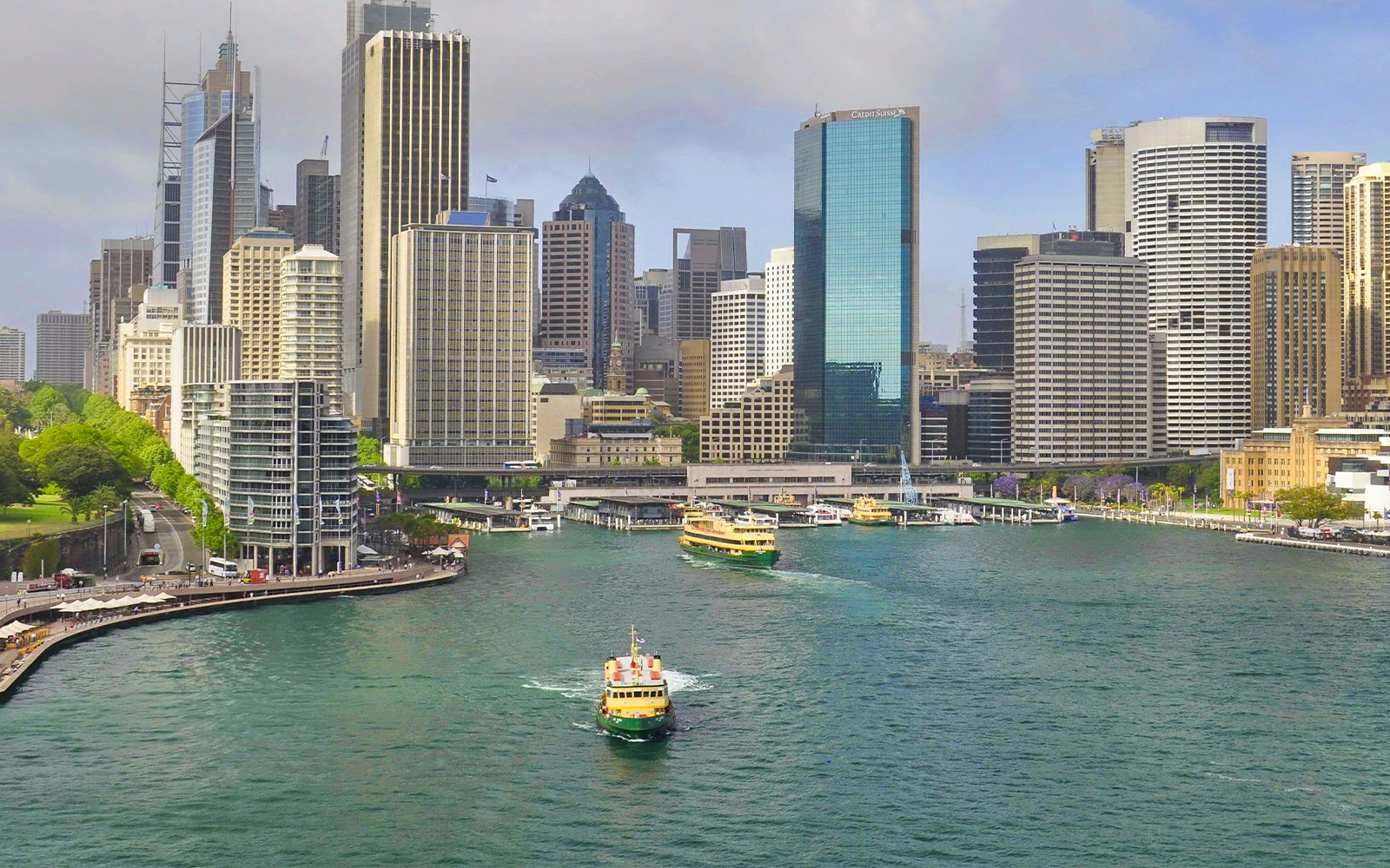 Ferry cruising through Sydney Harbour with city skyline in the background.