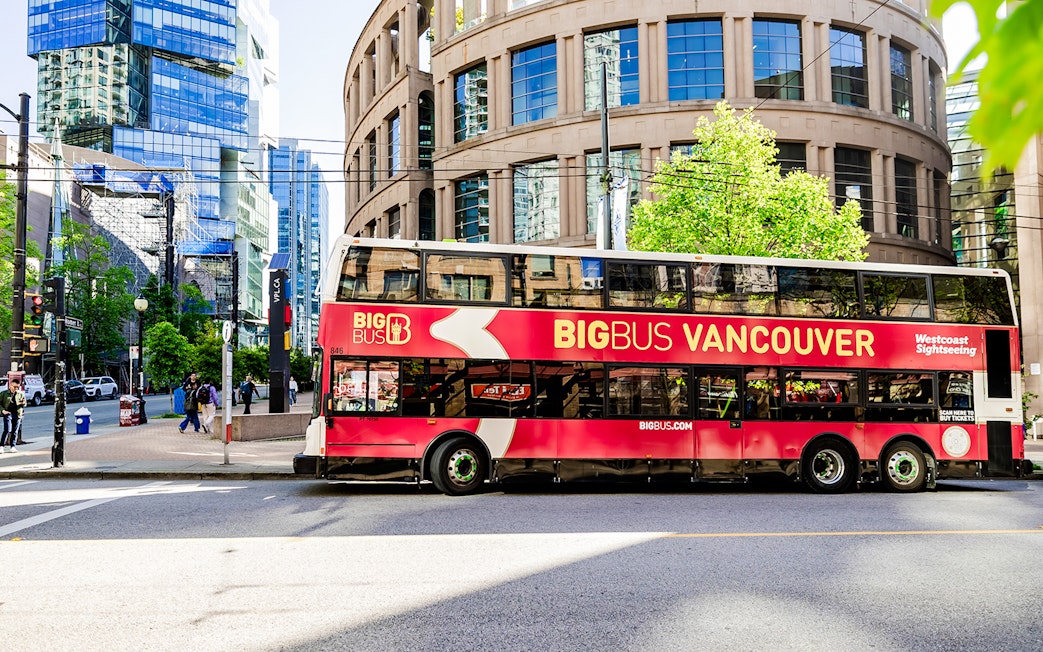 Big Bus Vancouver double-decker in front of city library.