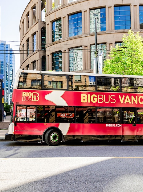 Big Bus Vancouver double-decker in front of city library.