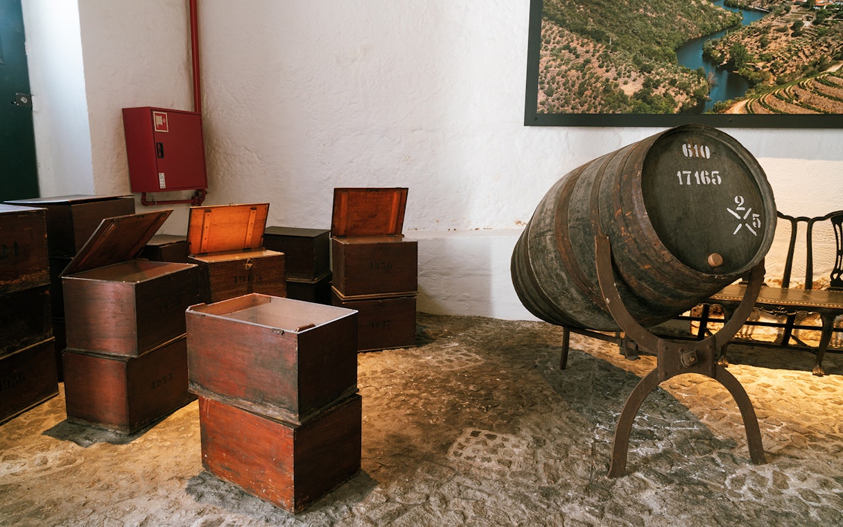 Barrel and wooden crates in Fonseca port wine cellar.