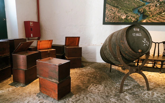 Barrel and wooden crates in Fonseca port wine cellar.