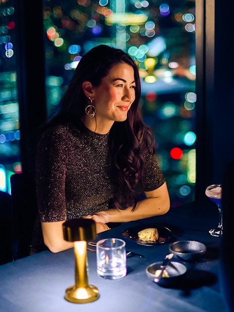 Couple dining at Melbourne Skydeck with city lights view.