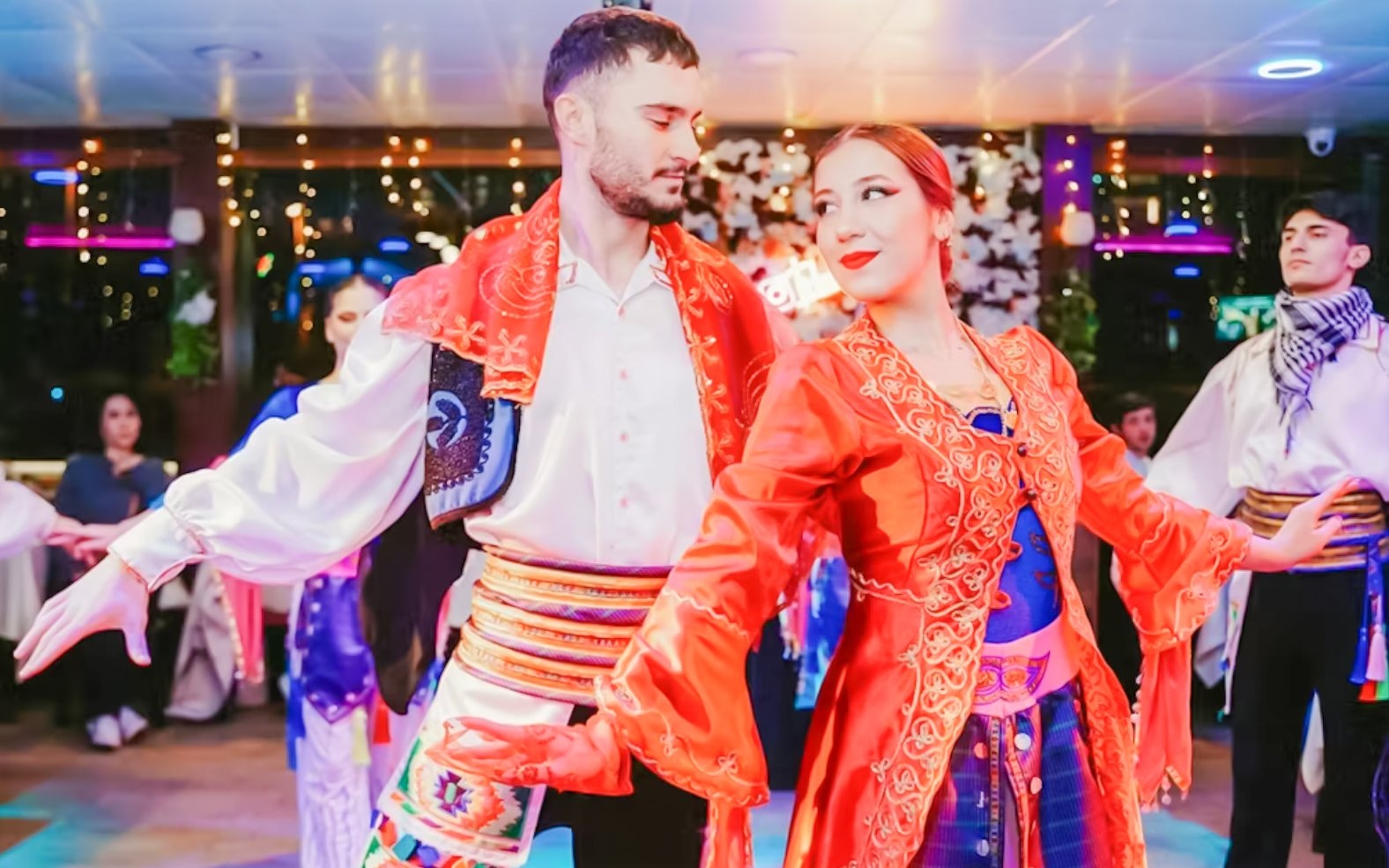 Dancers performing traditional dance on Bosphorus night cruise with live entertainment.