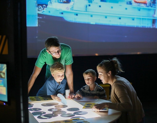 Children watching multimedia Film in USS Midway Museum