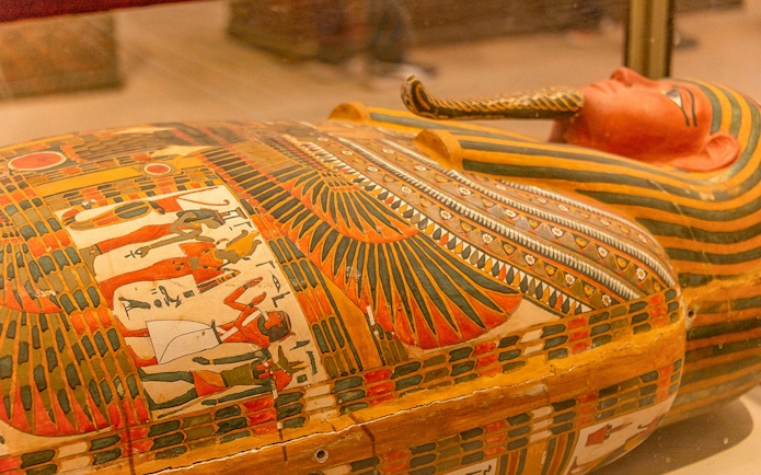 Sarcophagus with colorful hieroglyphics at the Egyptian Museum of Antiquities.