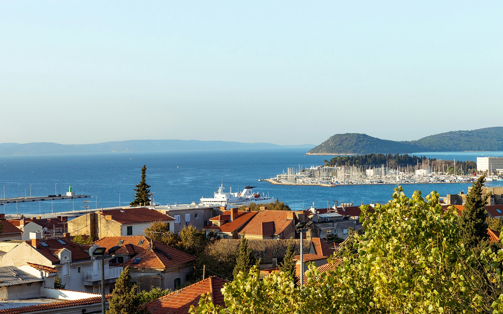 View of Split, Croatia with red rooftops, harbor, and distant hills from Gripe fortress hill.