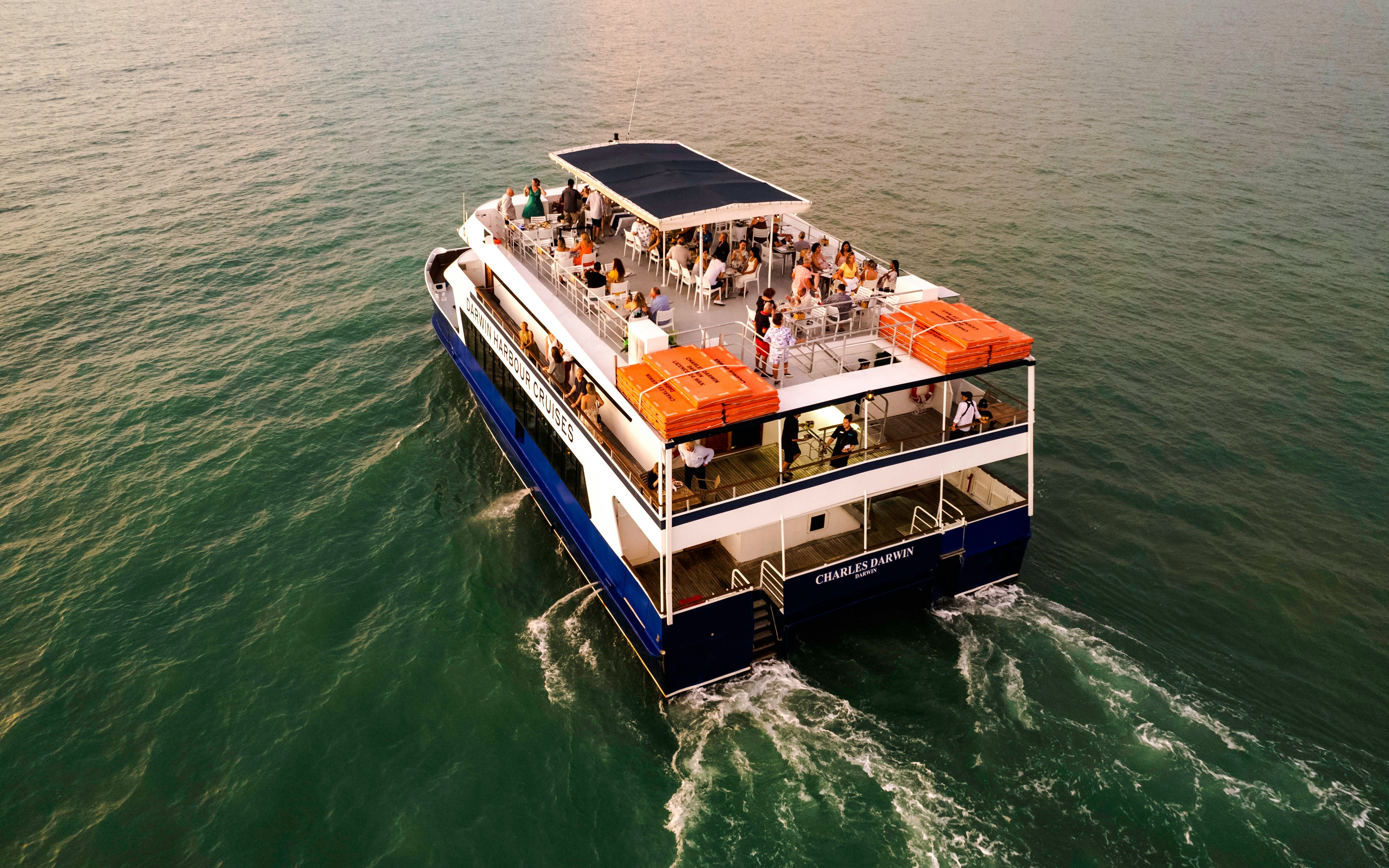 Darwin Harbour cruise ship with passengers enjoying a sunset dinner.