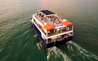 Darwin Harbour cruise ship with passengers enjoying a sunset dinner.