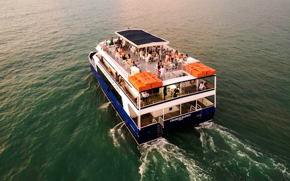 Darwin Harbour cruise ship with passengers enjoying a sunset dinner.