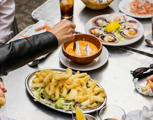 Participants trying seafood on a Tapas Tasting Tour in Seville