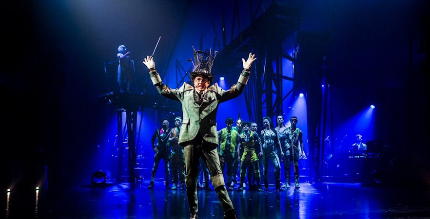 Performer leading Cirque du Soleil: Bazzar show in Meloneras with ensemble cast on stage.