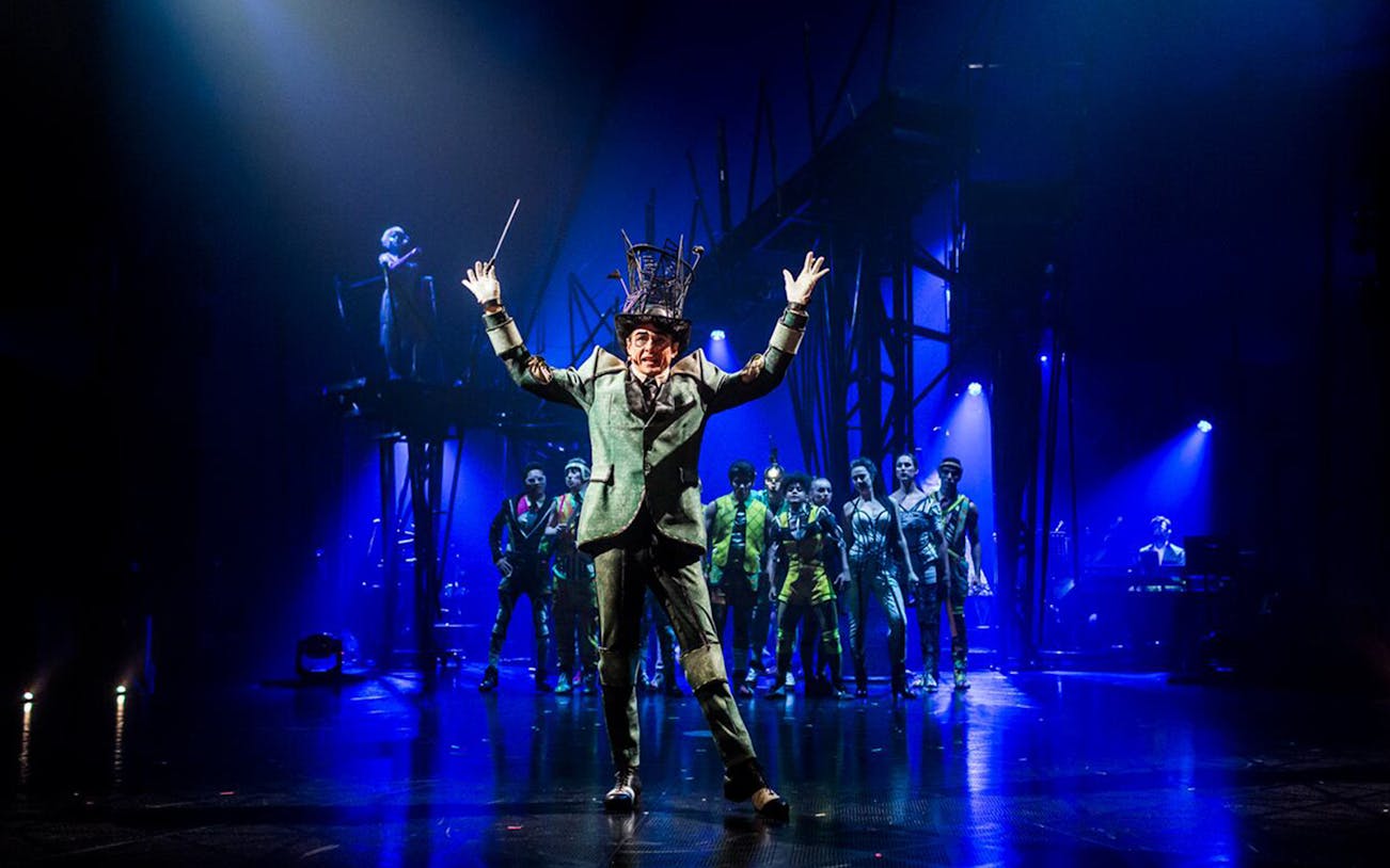 Performer leading Cirque du Soleil: Bazzar show in Meloneras with ensemble cast on stage.