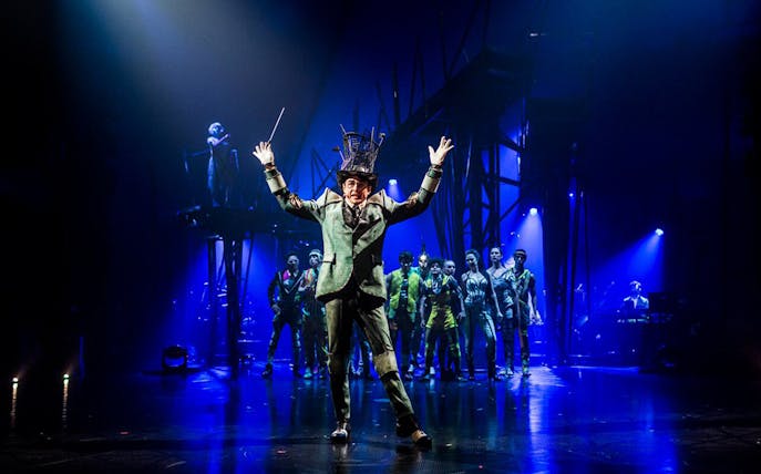 Performer leading Cirque du Soleil: Bazzar show in Meloneras with ensemble cast on stage.