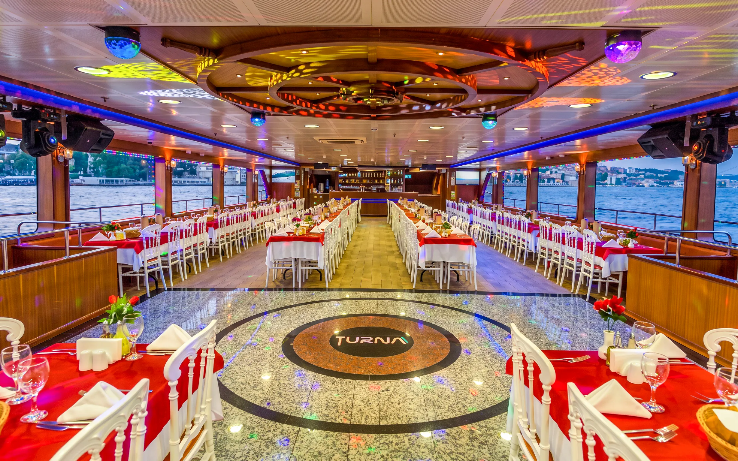 Bosphorus dinner cruise interior with tables set for dining, Istanbul.