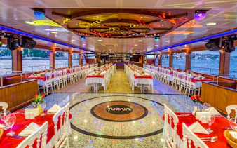Bosphorus dinner cruise interior with tables set for dining, Istanbul.